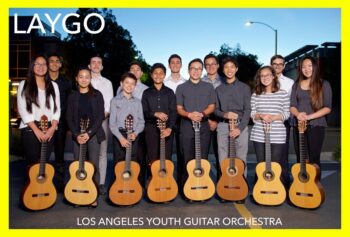 A group of guitar students pose with their instruments