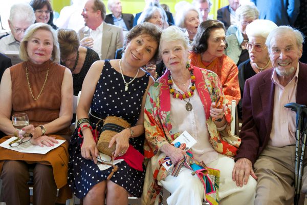 Elderly concert-goers sitting and smiling
