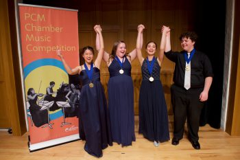 Young musicians with medals celebrating