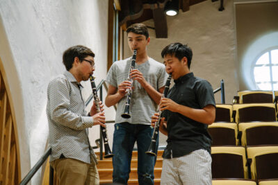 Three musicians playing clarinet