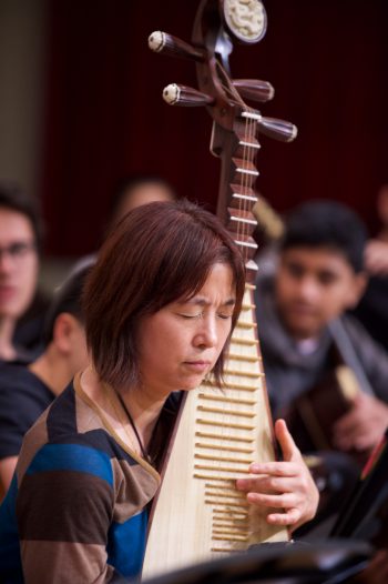 Woman playing instrument with many strings