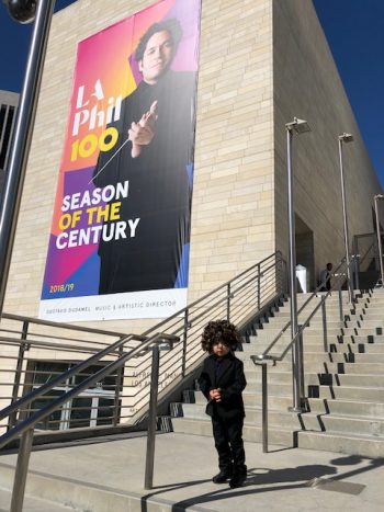 Child next to Dudamel poster outside of Disney Hall