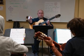 Guitar instructor teaching class