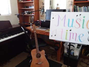 Music Time poster board in a room with instruments