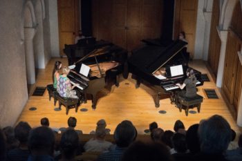 Four pianists playing in Barrett Hall