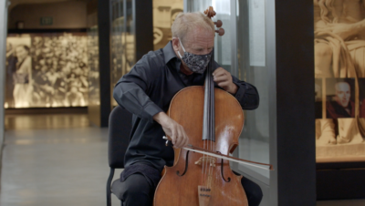 Man in face mask playing cello