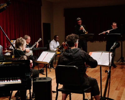 Adult jazz ensemble performs on stage