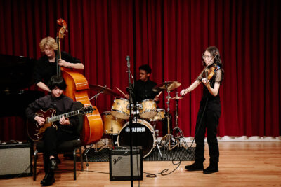 Young jazz ensemble performs on stage