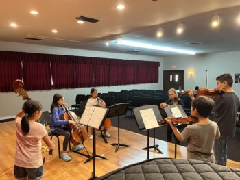 String musicians practice on stage