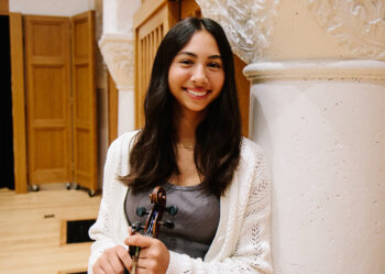 Young woman poses with her violin