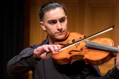 A young man plays viola