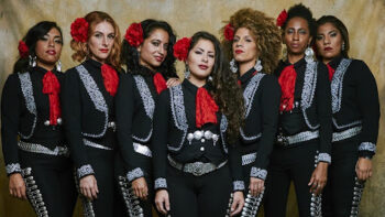 7 Mariachi women stand in a line.