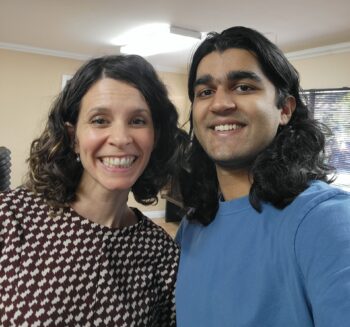 A man and woman take a selfie in a music studio