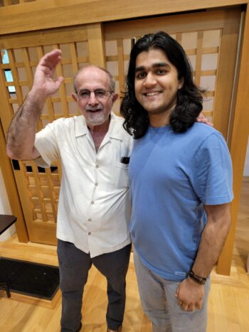 Two men take a photo in Barrett Hall