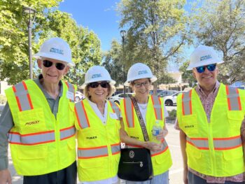 Four people in hard hats pose for the camera