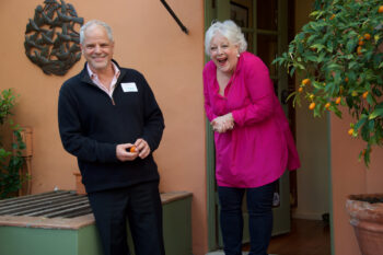 Man and woman laugh at a party