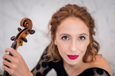 woman poses with instrument